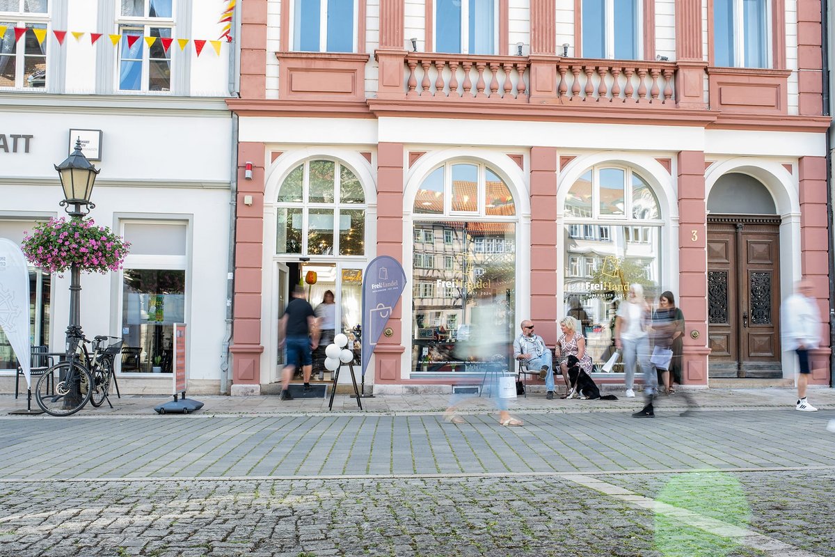 Straßenansicht des FreiHandel Mühlhausen am Steinweg 3 mit rosafarbener Fassade und Schaufenstern